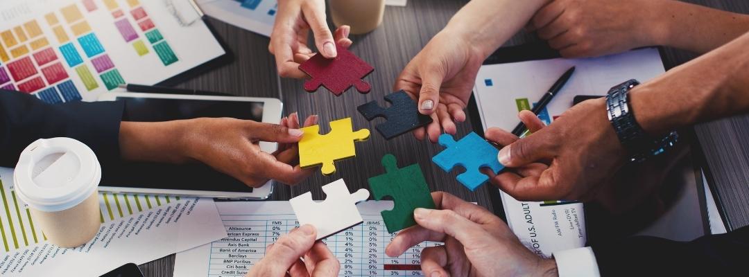 office colleagues solving puzzle at office